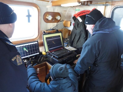 RCMP Members adjusting the sonar search / survey lines